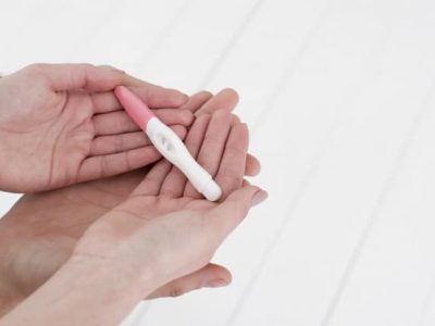 close-up-hands-holding-pregnancy-test_23-2148354814